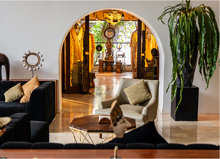Coworking lounge with an arched opening and plants.